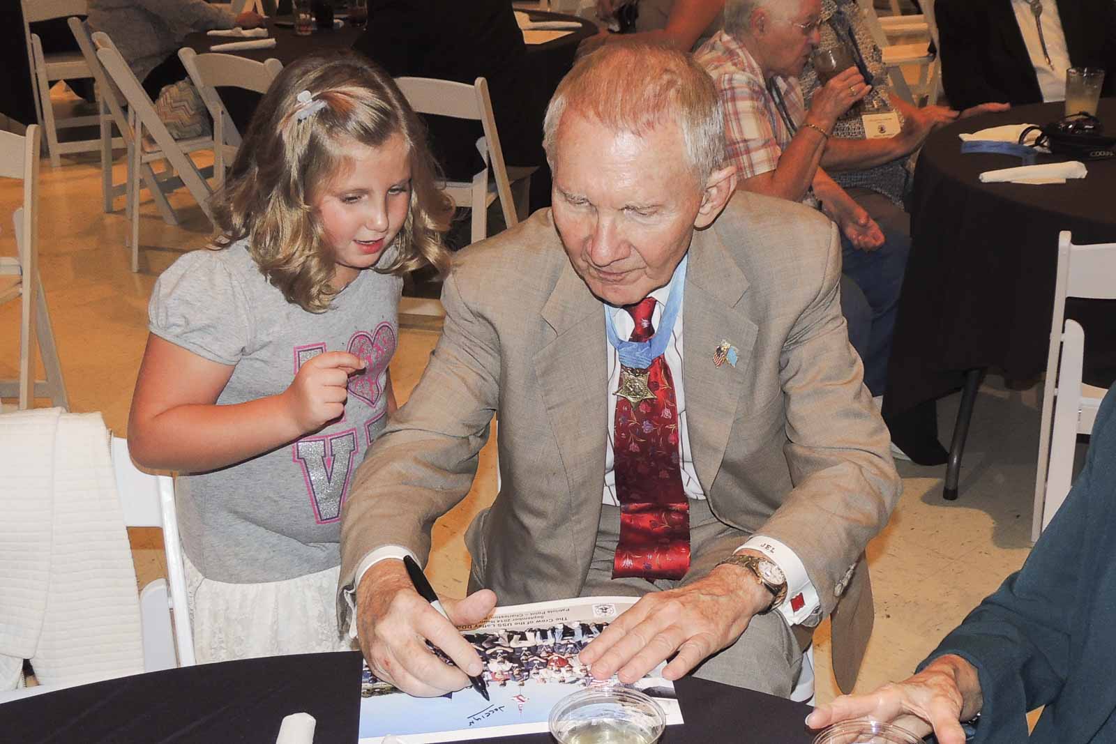 Celebrity Giving Autograph To Child - Patriots Point Foundation